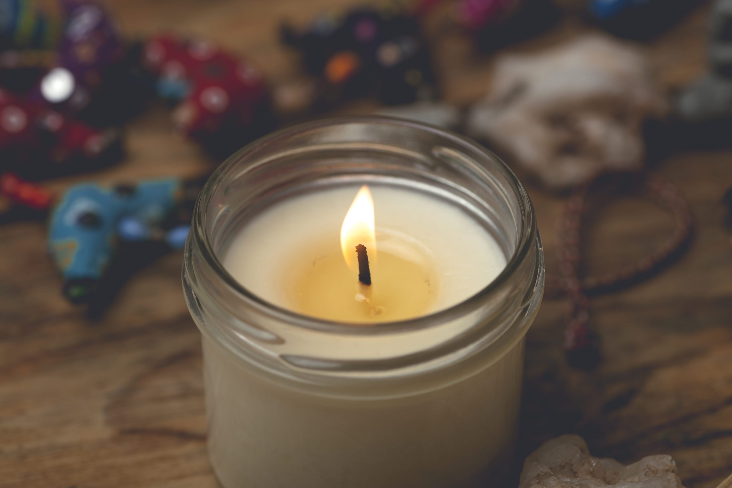 Homemade candle in a glass candlestick on a wooden table. Home comfort, aromatherapy and relaxation